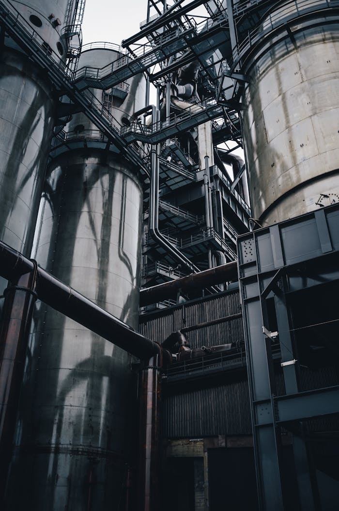 Low angle view of towering industrial silos in Luxembourg, showcasing modern production infrastructure.